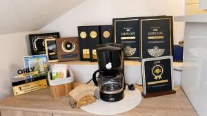 a coffeemaker sitting on a counter with books and boxes at Vila Harmónia in Turčianske Teplice