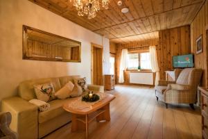 a living room with a couch and a table at Das Krumerhaus in Aschau