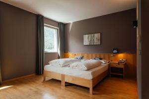 a bedroom with a bed and a window at Lodenwirt Residence in Vandoies +57 photos