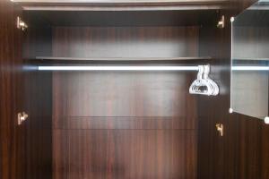 a bathroom with a wooden door with a light on it at Patong Canal Villa 308 in Patong Beach +8 photos