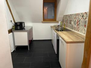 a small kitchen with a sink and a counter at Waldblick in Neresheim