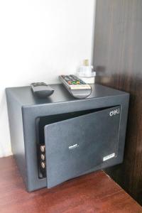 a tv with a remote control on top of it at Patong Canal Villa 308 in Patong Beach