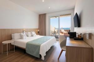 a hotel room with a bed and a balcony at RVHotels Ametlla Mar in L'Ametlla de Mar +58 photos
