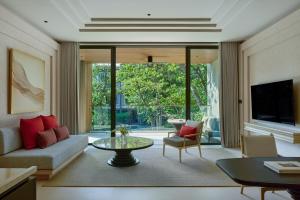 a living room with a couch and a table at THE BARAI HUA HIN - The Unbound Collection by Hyatt in Hua Hin