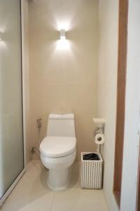a bathroom with a toilet with a light above it at Veranda Resort & Villas Hua Hin Cha Am in Cha Am