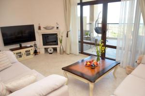 a living room with a couch and a table with fruit on it at Thracian Cliffs Owners Apartments in Kavarna