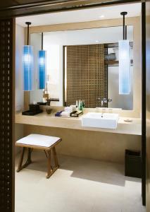 a bathroom with a sink and a bench and blue lights at Veranda Resort & Villas Hua Hin Cha Am in Cha Am
