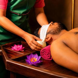 a man getting a massage in a bath tub at Sattvic Ceylon- Wellness Homestay in Colombo