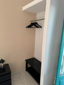 a black shelf in a room with a closet at Ontas in Tholária +2 photos
