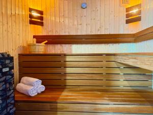 a sauna with two rolled towels on a wooden floor at Pokoje, apartamenty & sauna Siodemka Zakopane in Zakopane +77 photos
