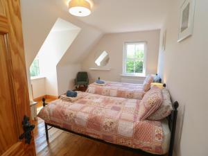 a bedroom with two beds and a window at The Skating Rock in Banane Bridge