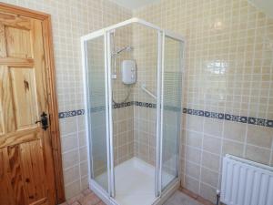 a shower with a glass enclosure in a bathroom at The Skating Rock in Banane Bridge +45 photos