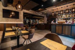 a restaurant with tables and chairs and a bar at Motel Gradina in Bosansko Grahovo