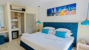 a bedroom with a large bed with a blue headboard at Tuệ House in Ấp Gia Thanh (1)
