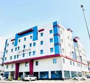 a building with cars parked in front of it at SBY Hotel فندق اس بي واي in Jeddah