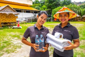 two women standing next to each other holding water bottles at Patong Canal Villa 308 in Patong Beach