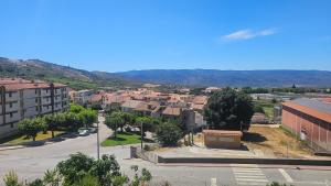 an aerial view of a city with buildings and a street at A Romãzeira in Torre de Moncorvo