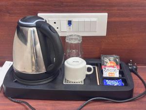 a coffee maker with a coffee mug on a tray at Raghuwar Palace in Ayodhya +49 photos