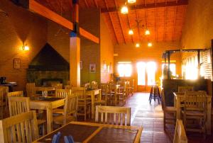 a dining room with wooden tables and chairs at Lauquen Pilmaiquen y spa in Merlo