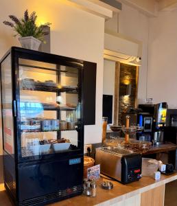 a counter with a display case with food on it at Les Palmiers in Fréjus