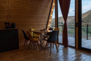a dining room with a table and chairs at Focus Point Drakhtik - Green Cabin in Drakhtik