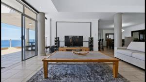 a living room with a couch and a coffee table at Santorini 402B in Margate