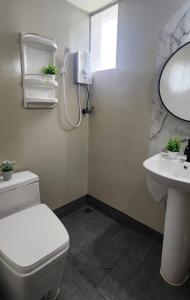a bathroom with a toilet and a sink at The City in Ban Si Than
