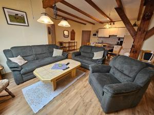 a living room with two couches and a coffee table at Ferienhof van Vlyten_ 45006 in Jemgum