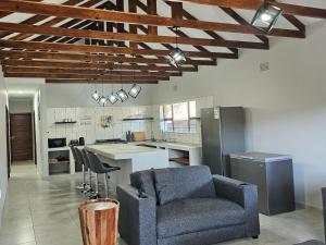 a living room with a couch and a kitchen at Wave Dancer 2-Bedroom Apartment in St Lucia