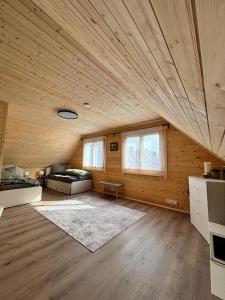 a large room with a wooden ceiling with windows at Modernes Blockhaus mit Sauna Flair in Lisberg