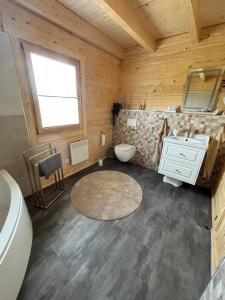 a bathroom with a white sink and a toilet at Modernes Blockhaus mit Sauna Flair in Lisberg +31 photos