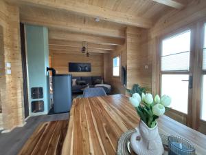 a living room with a table and a couch at Modernes Blockhaus mit Sauna Flair in Lisberg