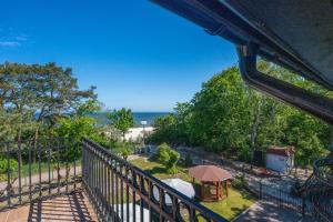 a balcony with a view of the beach and a gazebo at Ośrodek Wypoczynkowy AS PIK dawniej Hotel AS PIK in Niechorze