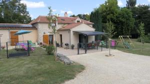 a house with a playground in the yard at Moulin neuf de combecave in Saint-Amand-de-Vergt