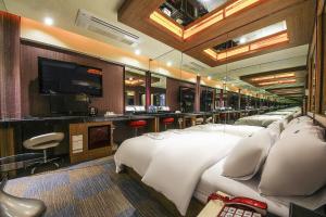 a hotel room with four beds and a flat screen tv at 부평 호텔 루와 in Pup'yŏng-yŏk