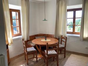 a dining room with a wooden table and chairs at Sallrain Hof Apartment 2 in Collalbo
