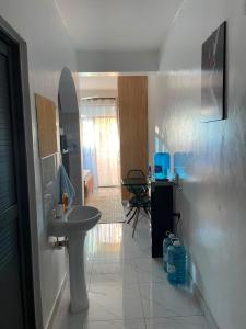 a bathroom with a sink and a mirror at royalnest bnb in Mombasa