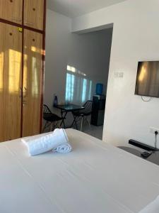 a white bed with a towel on top of it at royalnest bnb in Mombasa