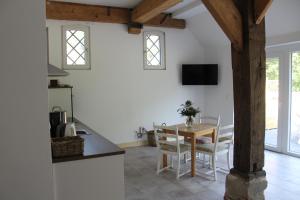 a kitchen and dining room with a table and chairs at Biohof Holthusen in Hammelwarder Außendeich