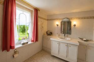 a bathroom with a sink and a window at Panoramaferienwohnung Bergwiese in Masserberg +26 photos
