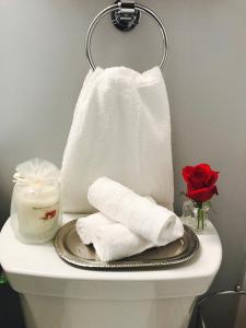 a toilet with two towels and a candle on it at Studio H St Corridor in Washington, D.C. +38 photos
