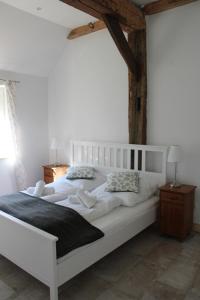 a white bed with two pillows on it in a bedroom at Biohof Holthusen in Hammelwarder Außendeich