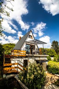 a house with a black roof and a balcony at Galaxy6189 Guesthouse in Tapolca