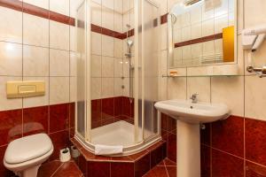 a bathroom with a shower and a toilet and a sink at Guesthouse Villa Adria in Malinska +19 photos