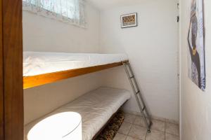 a small room with a bunk bed and a ladder at La Ballito 402 in Ballito