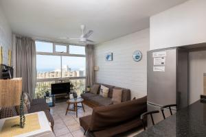 a living room with a couch and a fireplace at La Ballito 402 in Ballito