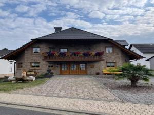 a large brick house with a large driveway at Ferienwohnung Ahrtalfreude in Sinzig