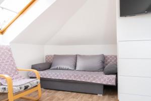 a living room with a couch and a chair at Soukromý byt v centru Velkého Meziříčí in Žďár nad Sázavou