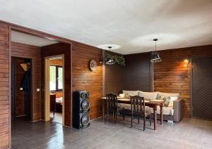 a living room with a table and a dining room with at Meiranu krasts in Bērzgale +53 photos
