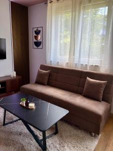 a living room with a couch and a coffee table at SkyLux Premium Zenica in Zenica